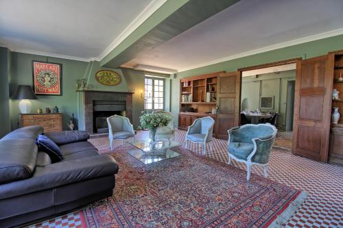 a living room with a couch and chairs and a fireplace at Les chambres du Chateau de Farge-Allichamps in Farges-Allichamps