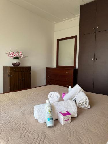 a bedroom with a bed with towels and a mirror at Vistas Venecianas Corfu in Corfu