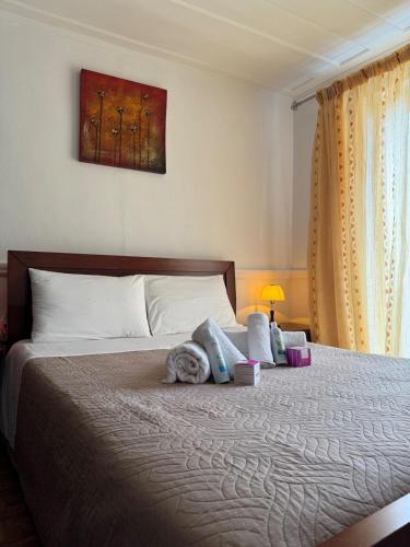 a bedroom with a bed with a cat laying on it at Vistas Venecianas Corfu in Corfu