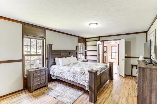 a bedroom with a bed and a flat screen tv at Hot Tub and Fire Pit Getaway in Sevierville! in Sevierville