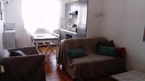 un salon avec un canapé et une table dans l'établissement Agréable T2, calme à la plage, RDC, Parking privé, à Canet