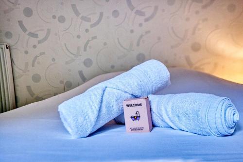 a pair of white socks on a bed with a box at le logis des remparts in Périgueux