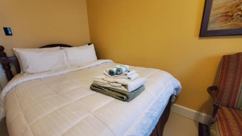 a bedroom with a bed with towels on it at The Empire House Hotel and Restaurant in Gilbertsville