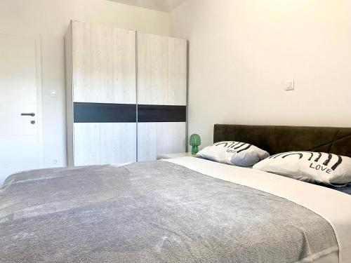 a bedroom with a large bed and a wooden cabinet at Bubble in Trogir