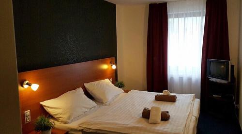 Ein Bett oder Betten in einem Zimmer der Unterkunft Hotel ELMA