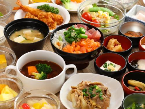 a table topped with bowls of different types of food at Dormy Inn Asahikawa in Asahikawa