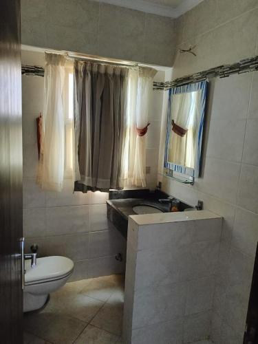 a bathroom with a sink and a toilet and a mirror at Aqua View Chalet at Piacera Resort-Ain Sokhna in Ain Sokhna