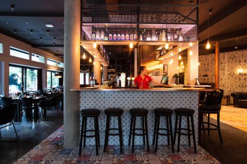 a bar in a restaurant with a person in the background at Pointe Isabelle in Chamonix-Mont-Blanc