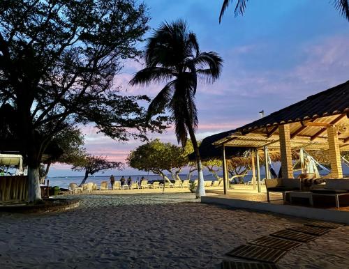 a pavilion with a view of the beach at dusk at Hotel Carey Beach Baru in Baru