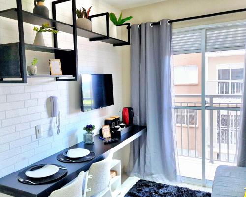a living room with a table and a window at Laguna 1412 - Moderno e Funcional in Sao Paulo