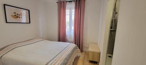 une petite chambre avec un lit et une fenêtre dans l'établissement Apartment of 32 m2 2 min from the beach Fréjus, à Fréjus