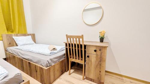 a small bedroom with a bed and a mirror at Spacious Rooms - 15 Min from Airport & City Center, 5 Min from Vienna Main-Bus Station EZ1 in Vienna