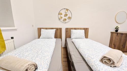 two beds sitting next to each other in a room at Spacious Rooms - 15 Min from Airport & City Center, 5 Min from Vienna Main-Bus Station EZ1 in Vienna