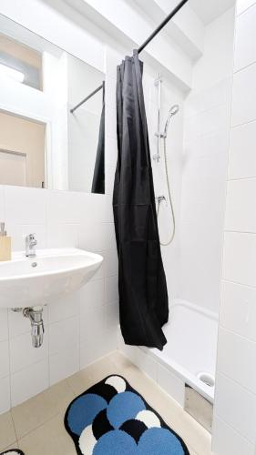 a bathroom with a sink and a shower at Spacious Rooms - 15 Min from Airport & City Center, 5 Min from Vienna Main-Bus Station EZ1 in Vienna