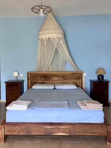 a bedroom with a bed with a mosquito net at Villas Nies in Soúrpi
