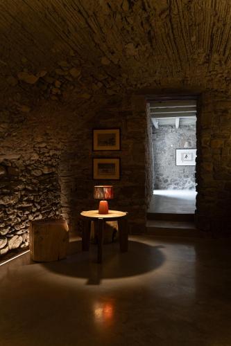 a dark room with a table and a window at Mas Margot in Llorá