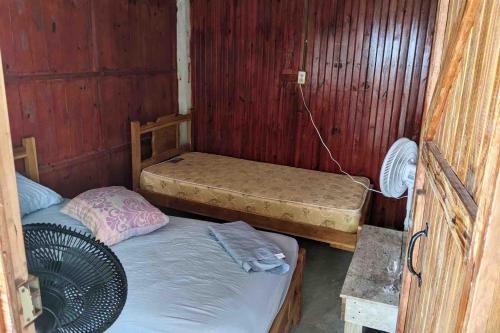 a room with two bunk beds and a fan at Room on Barco Hundido Island in Panama City