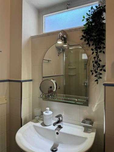 a bathroom with a sink and a mirror at Dimora San Domenico in Palermo