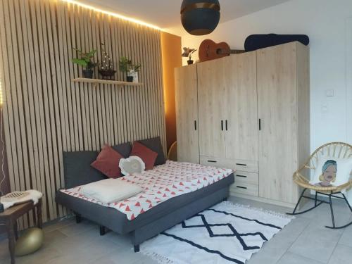 a bedroom with a bed and a cabinet and a chair at House in Jupille-sur-Meuse with terrace and barbecue in Jupille