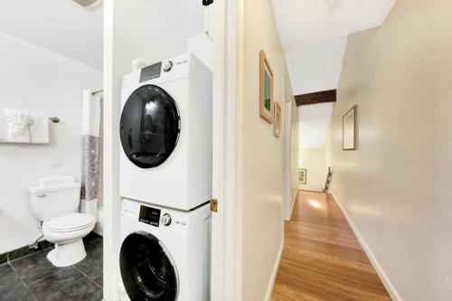 a bathroom with a washing machine and a toilet at Kauai Banyan Harbor B24 by Coldwell Banker Island Vacations in Lihue