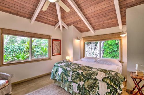 a bedroom with a bed and two windows at Kauai Hale Melemele by Coldwell Banker Island Vacations in Kapaa