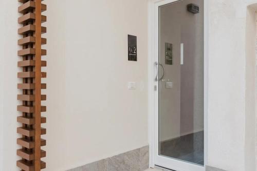 a bathroom with a shower with a mirror at Lazzara 19 in Marsala
