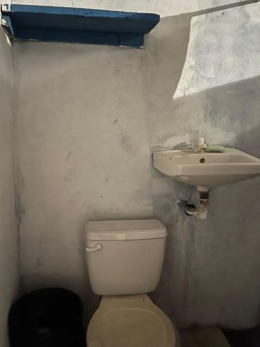 a bathroom with a toilet and a sink at Pelican House in Rivas