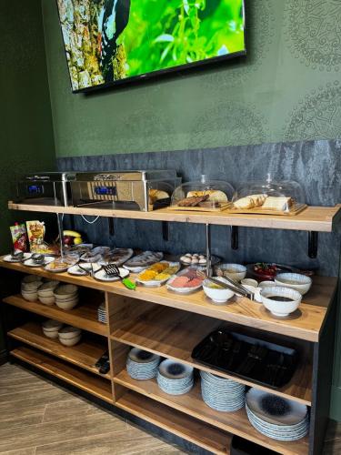 a shelf filled with different types of food at Turon City Hotel in Samarkand