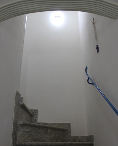 a white wall with a fireplace and a broom at The twins Rooms in Marettimo 2 in Marettimo