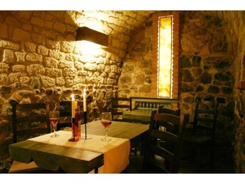 a table with wine glasses and a candle on it at Hotel Diafan in Baia Mare