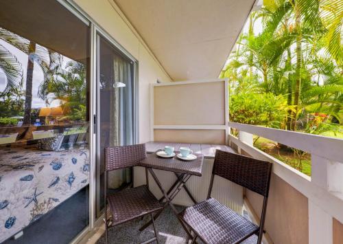 a small table and two chairs on a balcony at Kauai Plantation Hale Suites C8 by Coldwell Banker Island Vacations in Kapaa