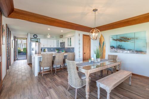 a kitchen and dining room with a table and chairs at Kauai Poipu Kapili 51 by Coldwell Banker Island Vacations in Kipu