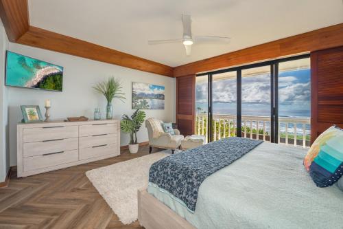 a bedroom with a bed and a view of the ocean at Kauai Poipu Kapili 51 by Coldwell Banker Island Vacations in Kipu