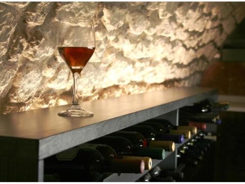 a glass of wine sitting on top of a table at Hotel Diafan in Baia Mare