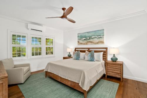 a bedroom with a bed and a ceiling fan at Kauai Wainani Villa by Coldwell Banker Island Vacations in Koloa