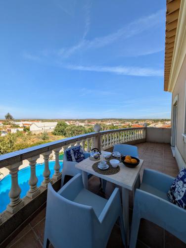 a table and chairs on a balcony with a view at Apartamento Golfinho in Sagres