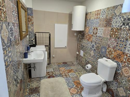 a bathroom with a toilet and a sink at Apartmány Modrý Dom in Podhájska