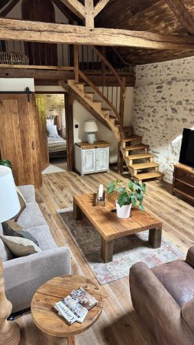 a living room with a couch and a table at Gîte entier - Alleu des Bois in Oyré