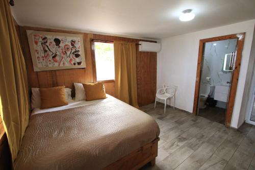 a bedroom with a bed and a bathroom at Casa Rural El Paraíso de Saona in Mano Juan