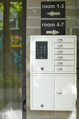 a microwave oven sitting on the side of a building at 7rooms - Self Check-in in Gütersloh