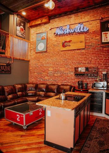 a living room with a brick wall and a bar at The Law Suites in Nashville