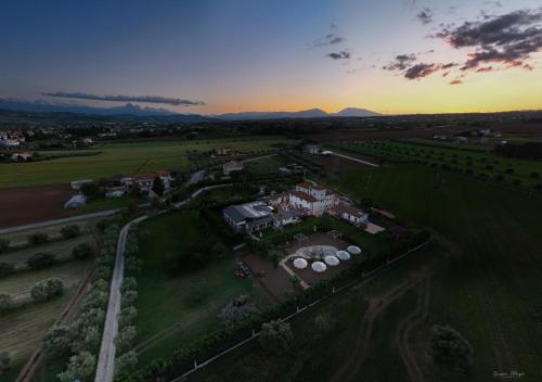 an aerial view of a house in a field at sunset at Moliké country house in Giulianova
