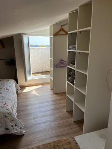 une chambre avec un lit et une fenêtre dans l'établissement Appartement duplex climatisé, à Frontignan