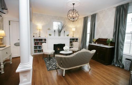 a living room with a table and chairs and a fireplace at The Harrison Inn in Cape May