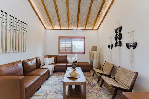 a living room with a brown leather couch and chairs at Waterfront Villa with Beach, Game Room, Cinema and Spa in Pembroke Pines