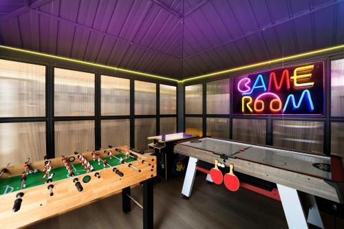 a room with a ping pong table and a game room at Waterfront Villa with Beach, Game Room, Cinema and Spa in Pembroke Pines