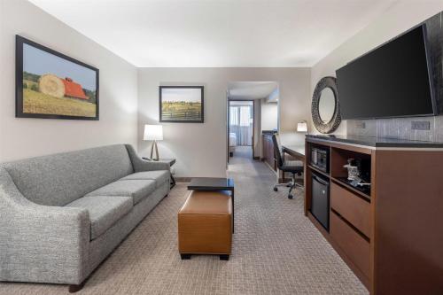a living room with a couch and a flat screen tv at Drury Inn & Suites Paducah in Paducah