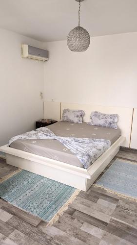 a large bed in a bedroom with a rug at Luxury Family Apartment Mahdia in Mahdia