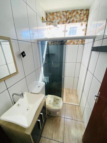 a bathroom with a sink and a toilet at Estalagem pé na areia in Arraial do Cabo