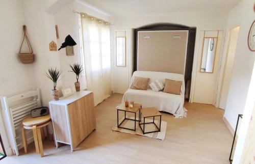 a small room with a bed and a table at Charmant studio proche mer avec piscine in Les Issambres